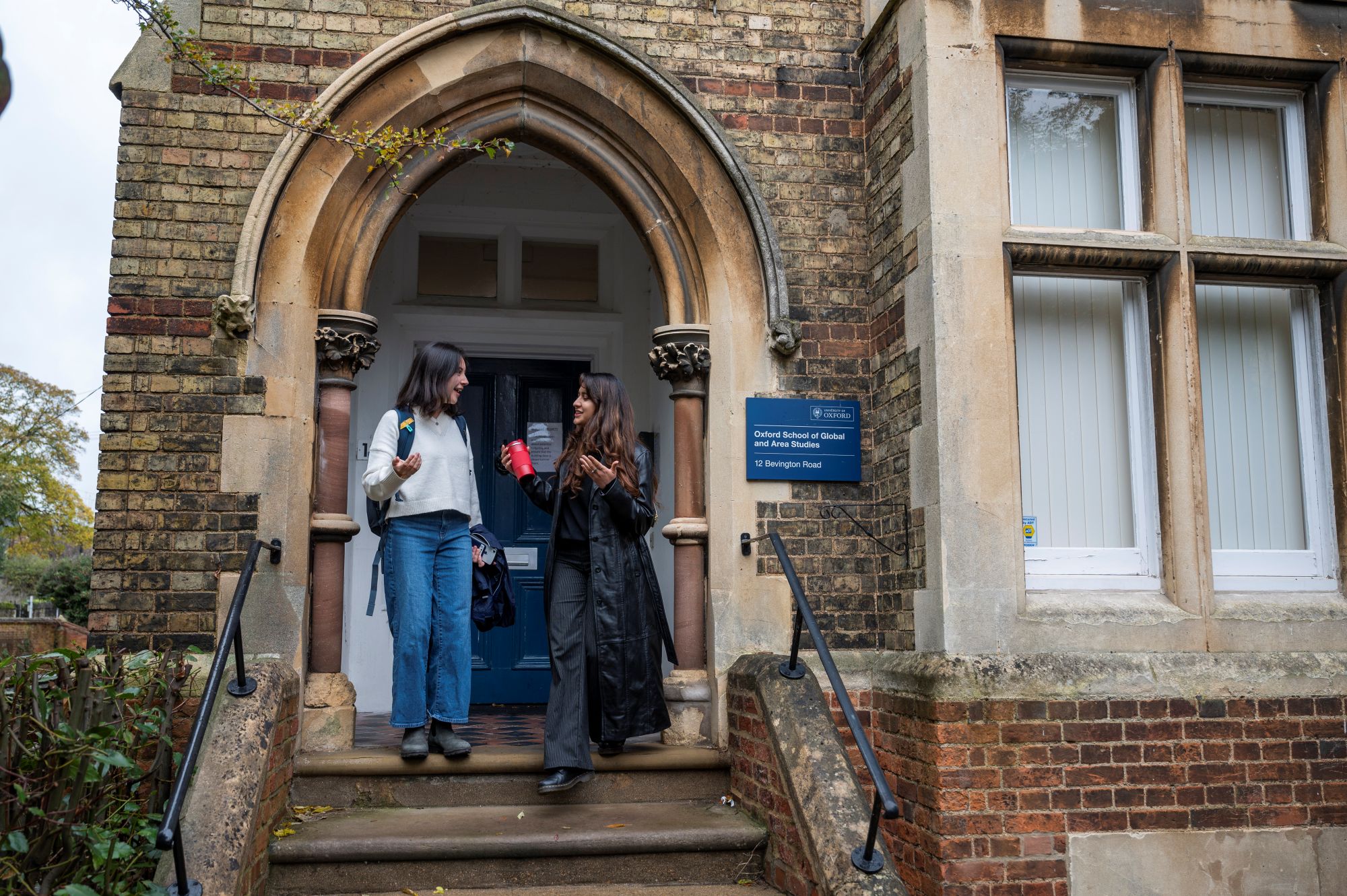 Student and member of staff walking down the steps outside OSGA Bevington road building