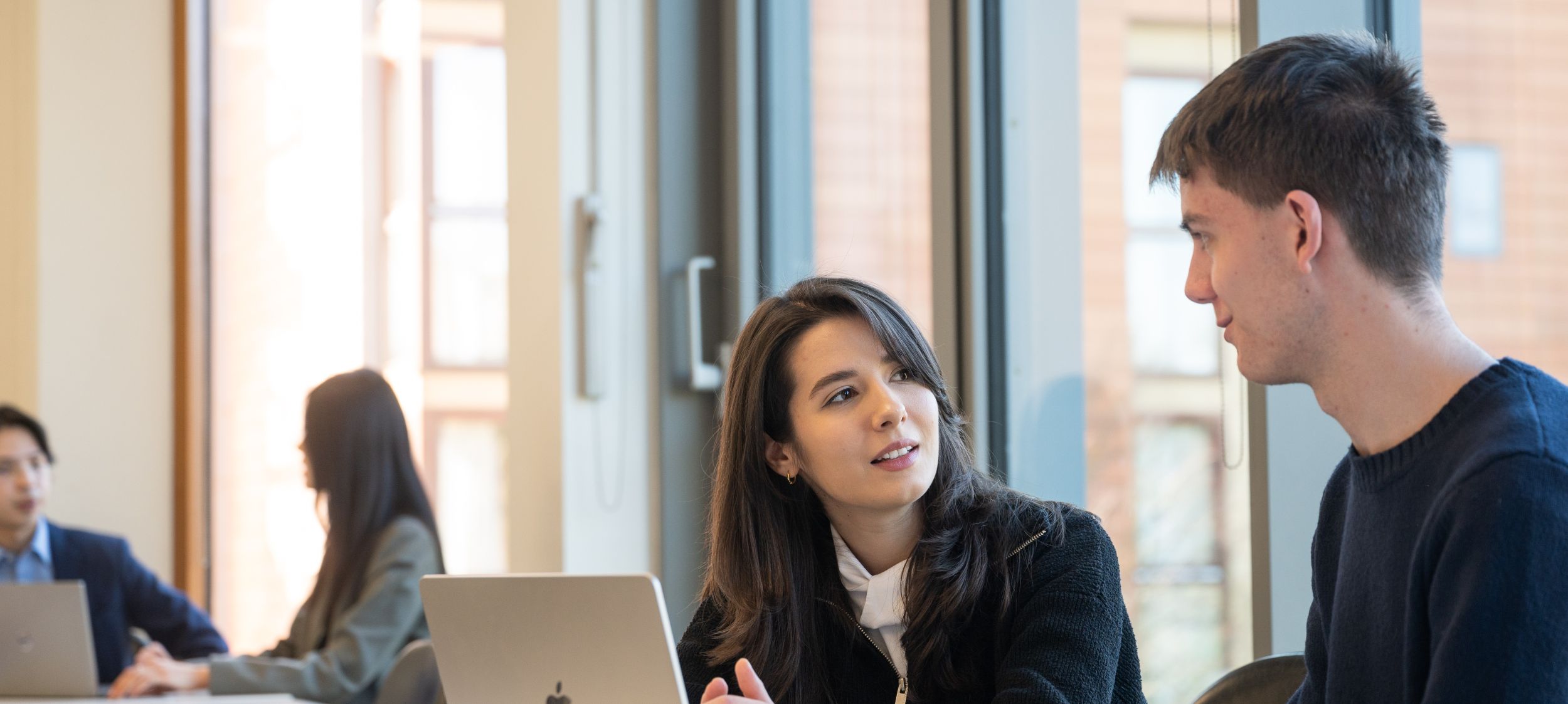Students looking at a laptop