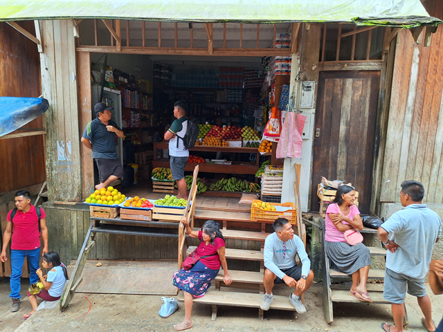 People outside a streetside grocery shop