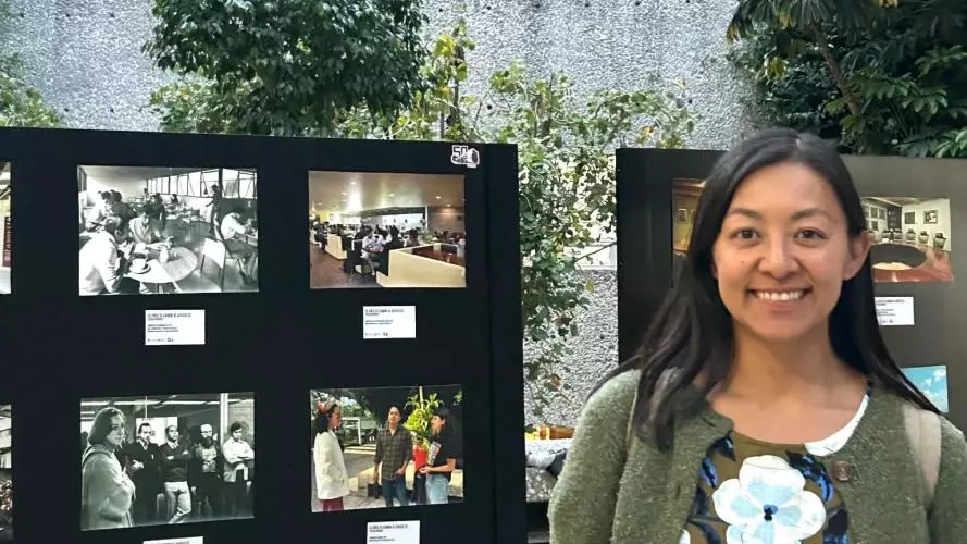 Jessica Fernandez de la Harada standing in front of exhibition board 