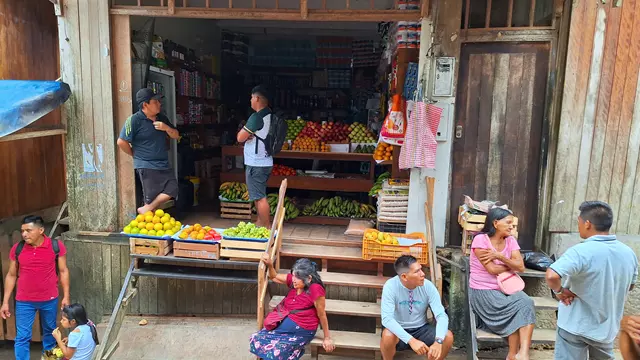People outside a streetside grocery shop