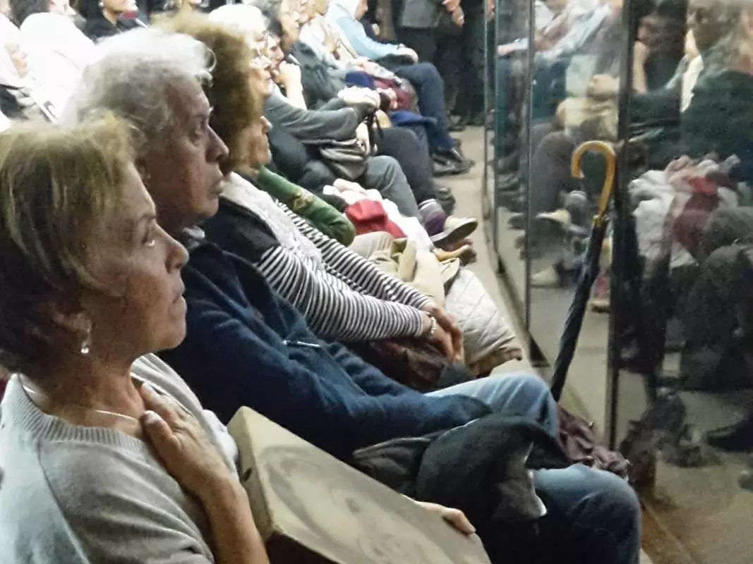 Relatives await the verdict in a 2016 Argentinian trial, sat behind a glass wall