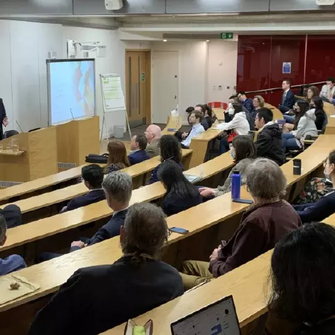 Mark Logan presenting to an audience in a lecture theatre