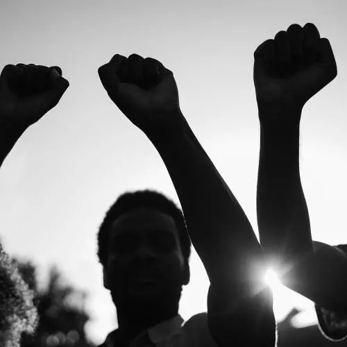 Three people with fists raised 