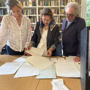 Grace Jaramillo, Rebeca Otazúa and Eduardo Posada-Carbó look at a sample of Rosemary Thorp archives kept in the library at the LAC.