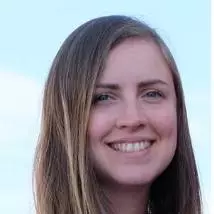 Marie has long brown hair, and is wearing a light blue top