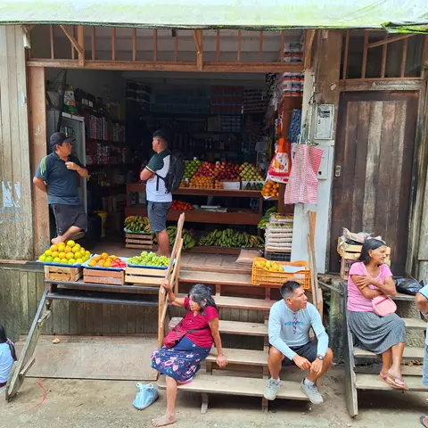 People outside a streetside grocery shop