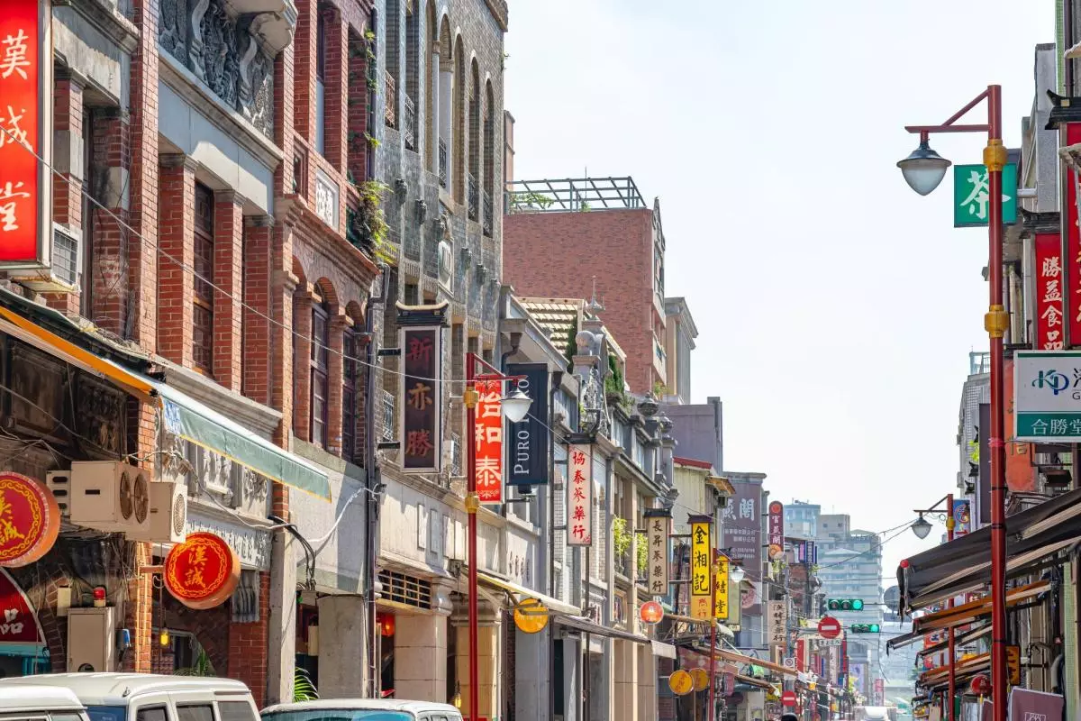 A view of a street in Taiwan, filled with colourful shop signs on either side. Credit: Shawn.cf - stock.adobe.com